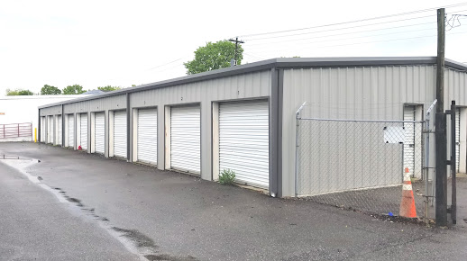 Drive-up storage building with white roll-up doors at Lawrenceburg Self Storage